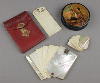 A 19th Century circular papier mache snuff box with fete gallant view and 3 aide memoirs 
