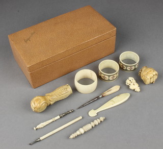 A 19th Century carved ivory parasol handle in the form of a hand clutching a ball 3", minor ivory and bone items 