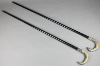 2 horn handled ebonised walking sticks with silver collars 