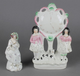 A Victorian Staffordshire figure group of 2 figures and a dog beneath a clock 10", a ditto of a seated lady 5 1/2" 