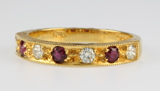 An 18ct yellow gold ruby and diamond ring, size O 1/2