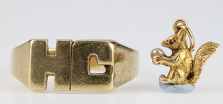 A 9ct gold ring size U 1/2 together with a 9ct gold charm, 8 grams