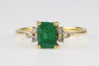 An 18ct yellow gold emerald and diamond ring, the rectangular cut emerald approx 0.5ct surrounded by 6 diamonds approx. 0.16ct size K 