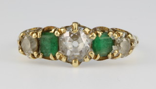 An 18ct gold diamond and emerald 5 stone ring, size L 1/2