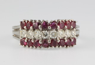An 18ct white gold ruby and diamond dress ring, size M