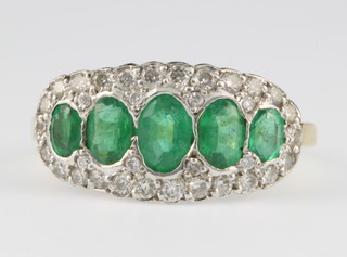 An 18ct emerald and diamond cluster ring, size H 1/2