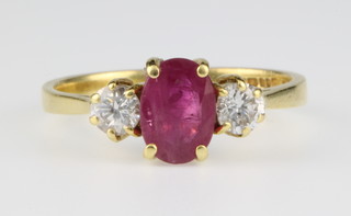 An 18ct yellow gold ruby and diamond ring, the ruby approx. 1ct with 1 diamond to each shoulder 0.4ct, size L