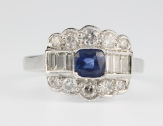 An 18ct white gold sapphire and diamond cluster ring, the centre sapphire 0.4ct surrounded by 16 diamonds size O 1/2