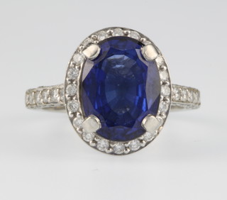 A platinum sapphire and diamond cluster ring with diamond shoulders, size J