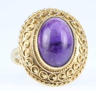 A 9ct gold cabouchon cut amethyst etruscan style ring, size N