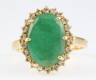 A yellow gold emerald and diamond cluster ring, size M 1/2