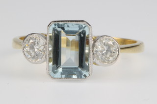 An 18ct gold aquamarine and diamond 3 stone ring, the aquamarine approx. 1.25ct flanked by 2 brilliant cut diamonds approx 0.4ct, size N 1/2