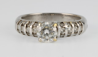 An 18ct white gold diamond ring, the centre stone approx 0.75ct with 12 stone diamond shoulders, size K 1/2