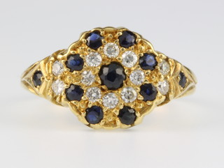 An 18ct yellow gold sapphire and diamond cluster ring, size N 1/2 