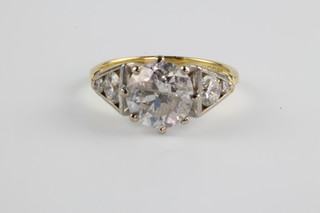 An 18ct yellow gold diamond ring, the centre stone approx 2.1ct with 2 brilliant cut diamonds to each shoulder, size K 1/2, together with an IGR report