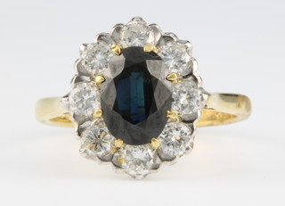 An 18ct yellow gold sapphire and diamond cluster ring, the centre stone approx 1.5ct surrounded by 8 brilliant cut diamonds, size P 