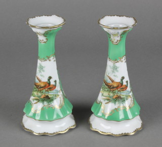 A pair of Limoges style tapered candlesticks the green ground decorated with birds 6" 