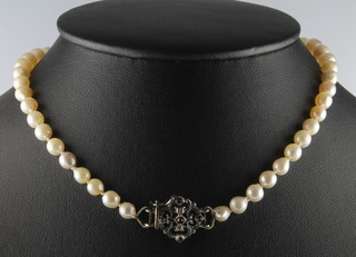 A string of graduated cultured pearls with a gem set silver clasp 15" 