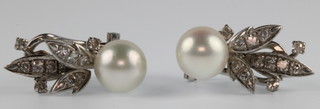 A pair of 14ct white gold diamond and pearl ear clips