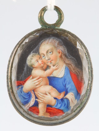 A 19th Century Continental oval pendant painted with a study of the Madonna and child