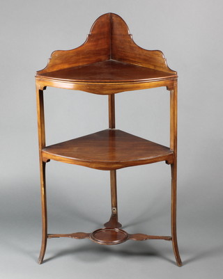 A 19th Century mahogany 2 tier corner wash stand with three-quarter gallery, having a T framed stretcher, raised on outswept supports  41"h x 22 1/2"w x 19"d 