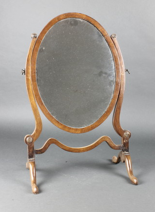 A Georgian style oval plate dressing table mirror contained in a mahogany swing frame 22"h x 15"w 