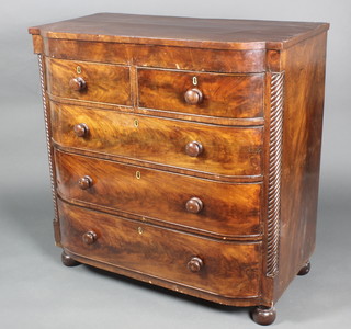 A 19th Century mahogany bow front chest of 2 short and 3 long drawers with tore handles and ivory escutcheons, having columns to the sides, raised on bun feet 42"h x 42"w x 22"d 