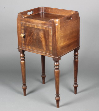 A Georgian mahogany tray top bedside cabinet enclosed by a panelled door, raised on turned supports 31"h x 17"w x 14"d 