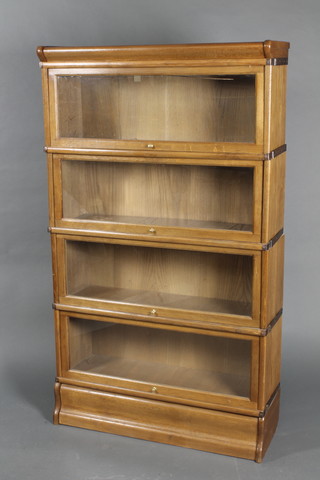 An oak 4 tier Globe Wernicke style bookcase 59"h x 34"w x 12"d 