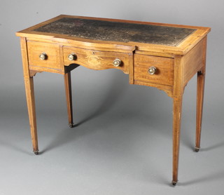 An Edwardian inlaid mahogany writing table of serpentine outline with inset writing surface, fitted 1 long and 2 short drawers on square tapering supports 29"h x 36"w x 19 1/2"d 