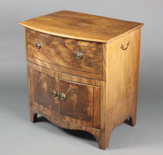 A Georgian mahogany bow front commode with hinged lid, the base fitted a cupboard enclosed by a panelled door 27 1/22h x 26"w x 15 1/2"d 