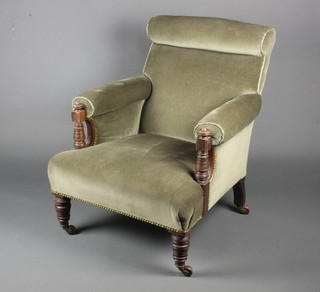 A Victorian mahogany Howard style armchair upholstered in green material 