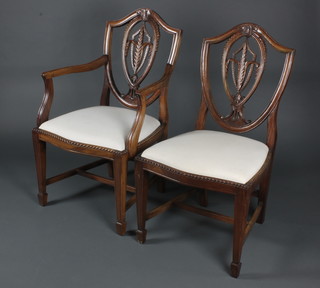 A set of 5 Hepplewhite style shield back dining chairs with Prince of Wales feathers, 1 with arms, raised on square tapering supports, spade feet 