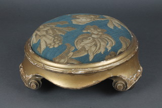 A circular Victorian carved and gilt painted footstool with upholstered drop in seat 4 1/2" x 12" diam.