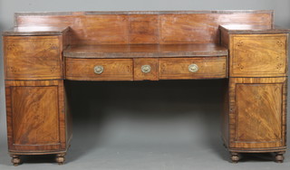 A Georgian mahogany pedestal sideboard with raised back fitted 2 long drawers, flanked by a pair of bow front cupboards fitted shelves enclosed by panelled doors 48"h x 87"w x 23 1/2"d 