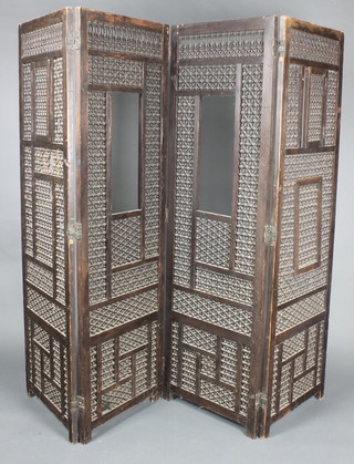 An Indian carved and pierced 4 fold screen 72"h x 22" when closed x 88" when open