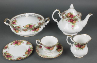 A Royal Albert Old Country Rose pattern tea and dinner service comprising large teapot, small teapot, milk jug, cream jug, sugar bowl, slop bowl, 11 tea cups, 11 saucers, 12 small plates, 12 medium plates, 12 dinner plates, 12 soup bowls, 2 serving plates, a cake stand, sauce boat, a tureen and cover, a tureen, a serving dish