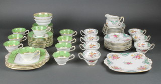 A Grosvenor China part tea set, the green ground with exotic birds and flowers comprising 9 tea cups, 2 bowls, 11 saucers, 12 sandwich plates and 4 serving plates and a Foley China part tea set comprising 7 tea cups, milk jug, 10 saucers, 10 sandwich plates and a serving plate 