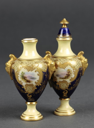 A pair of Coalport oviform vases with mask handles, the blue and gilt ground with landscape scenes 5"