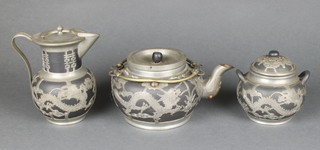 An early 20th Century Chinese earthenware tea service with metal mounts 