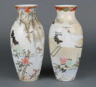 A pair of early 20th Century Japanese oviform vases decorated with heron amongst an extensive landscape 12" 