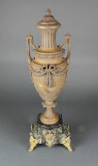 A Victorian spelter lidded twin handled urn raised on a stepped green marble base 22" 