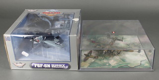 A Corgi model of a Lancaster bomber and spitfire, cased, together with a model of an F6F-M5 Night Hellcat 