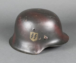 A German steel helmet marked CKL 66 1447, no liner