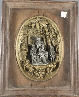 A 19th Century oval plaster relief plaque depicting mother and children 11" x 8" contained in an oak frame 