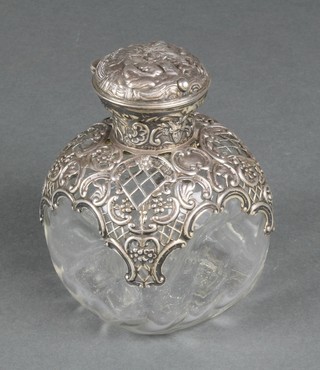 A Victorian silver mounted toilet bottle with pierced and scroll decoration showing a revelling scene, London 1896, 4" 