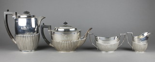 A silver demi-fluted 4 piece tea and coffee set with ebony mounts, London 1909, Sheffield 1910, gross 1378 grams 