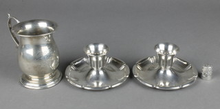 An Edwardian silver baluster mug with S scroll handle, Birmingham 1906, 106 grams, a pair of plated Danish candlesticks and a silver thimble