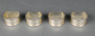 A set of 4 silver engine turned napkin rings with vacant cartouches Birmingham 1959, 126 grams  