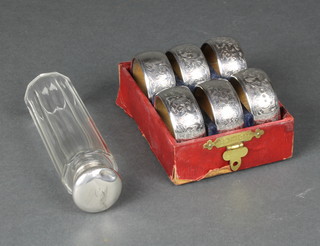 A set of 6 cased silver mounted napkin rings, Birmingham 1906 and a ditto toilet bottle 
